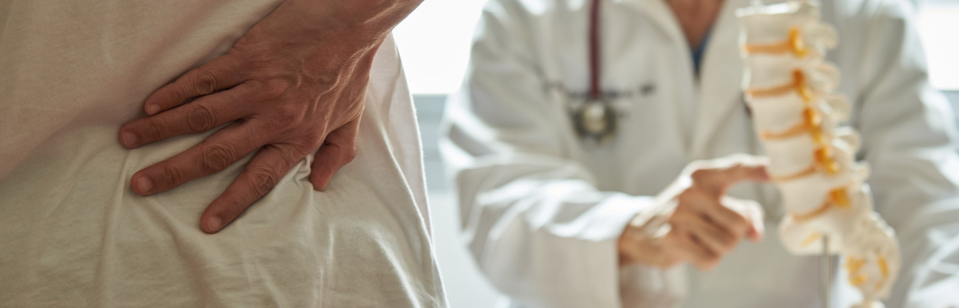 doctor pointing as spine model